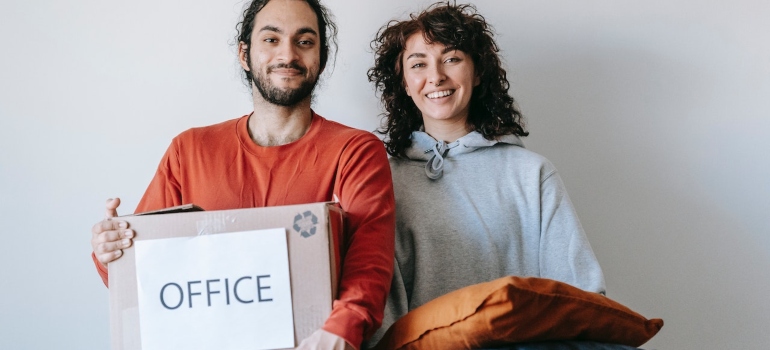 Picture of a couple moving a real estate office 