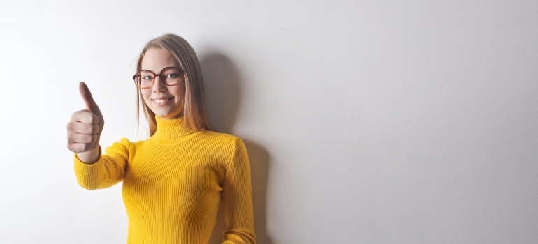 blonde woman showing thumbs up