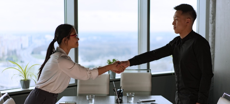 a woman and a man doing a handshake