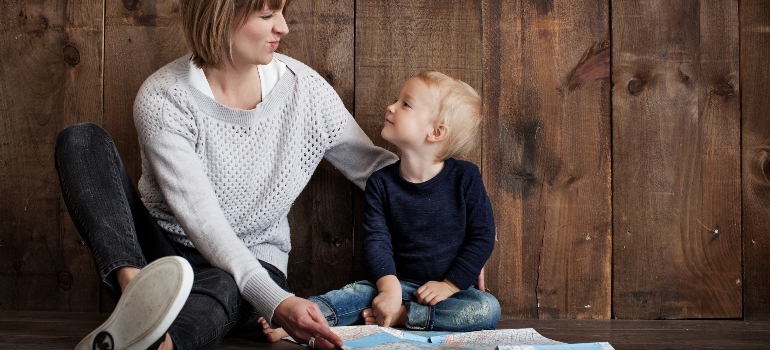 Single mother and her son looking at a map before moving out of Laguna Niguel after a divorce