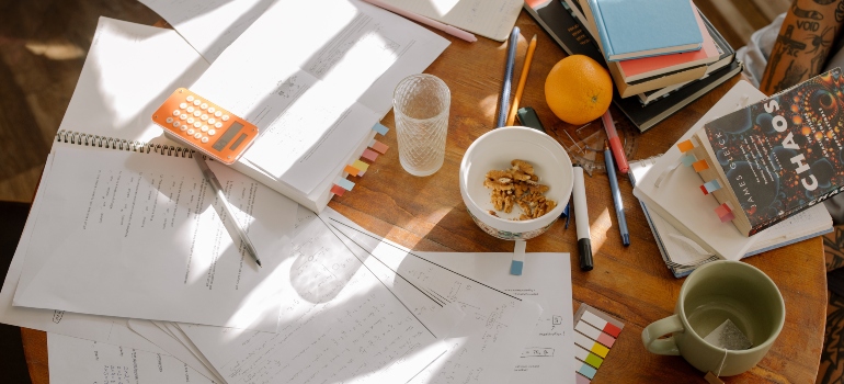 Table of a student with books and a Guide for Students Moving to Orange County