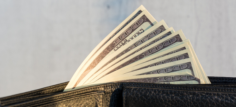 a wallet full of dollar bills, illustrating the cost-effectiveness as one of the reasons why you need a storage unit in a coastal city