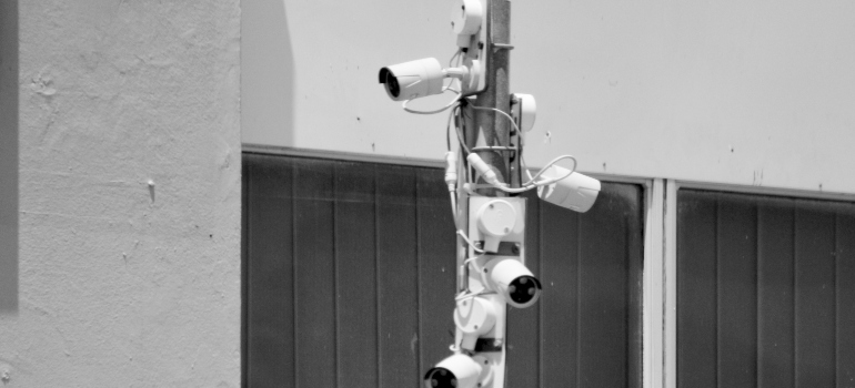 several surveillance cameras installed on a pillar 