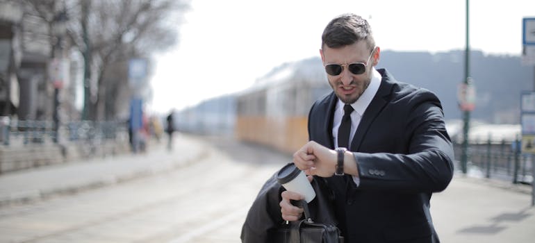 a busy man looking at his watch, who is a perfect candidate for moving into a fully furnished home