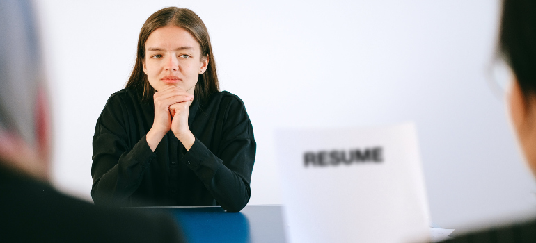 a woman with a worried look on her face attending a job interview