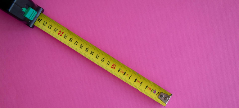 a measuring tape on a pink background