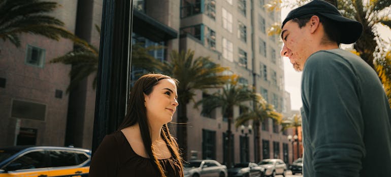 a woman talking to a man about the neighborhood 