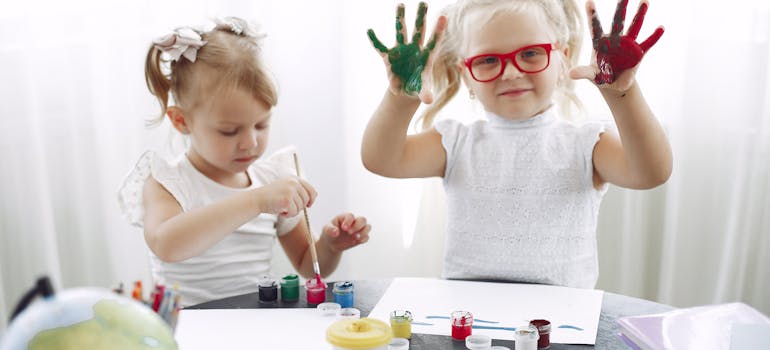 two kids playing with some paint