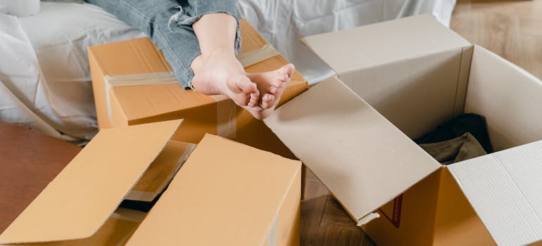 a woman with her feet on some cardboard boxes