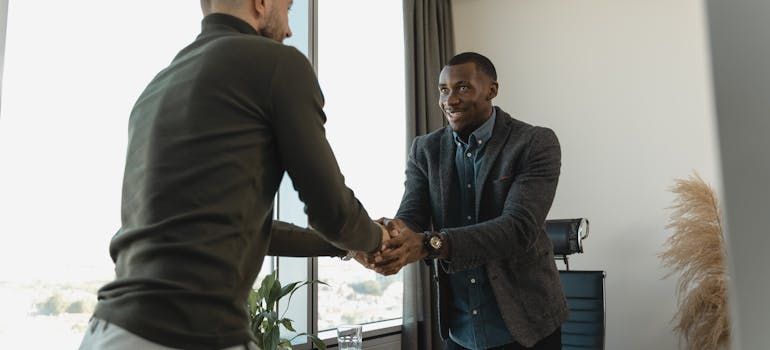 two men shaking hands after a successful job interview