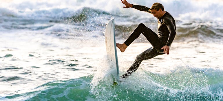 a man surfing, which is one of the ways to celebrate your birthday after moving to Huntington Beach