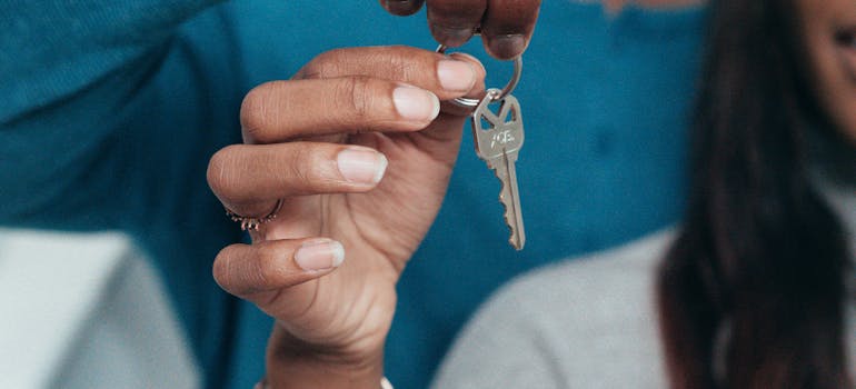 two people holding a house key together