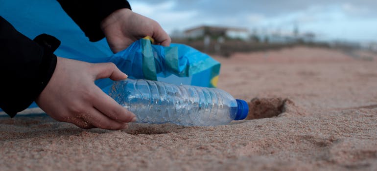 a person voluntarily cleaning a beach to fight addiction by moving to a coastal city 