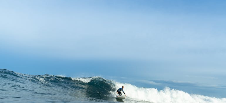 a man surfing on a day with clear sky