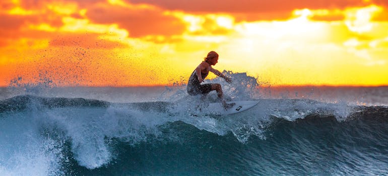 a man surfing at sunset