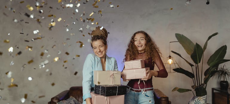 two people holding presents during a party