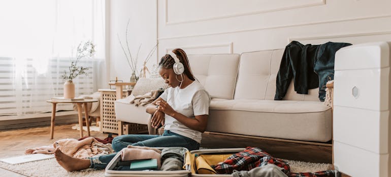 a woman packing her bags because she is moving out of a beach town