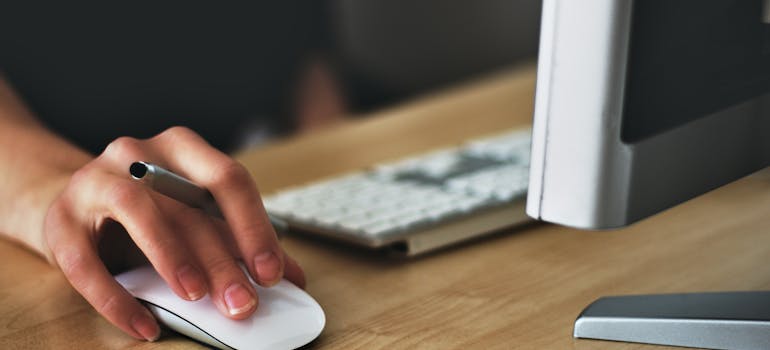 a person working on a computer before buying a house in Long Beach CA