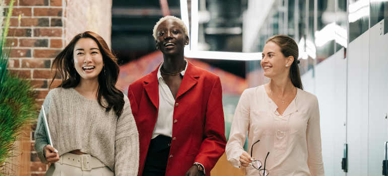 three women that look very happy while walking together