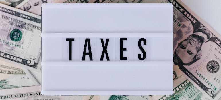 the word "taxes" on top of dollar bills