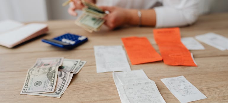 a woman paying bills for a small apartment