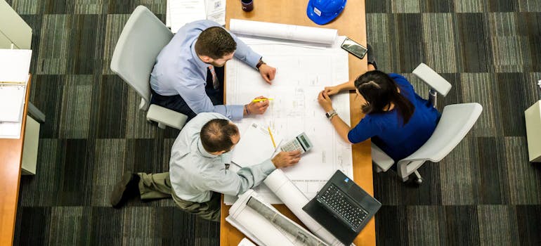 several engineers working together at a large table