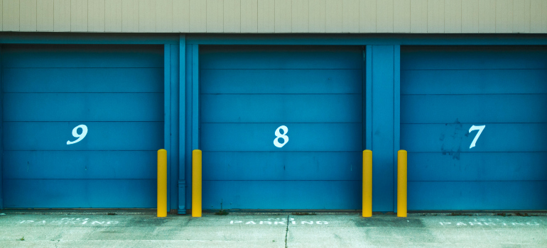 several storage units with blue doors and numbers on them