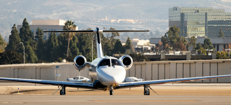 an airplane at the John Wayne Airport, which is part of the reasons why you should move your office to Orange CA