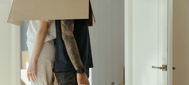 two people with their heads covered with a cardboard box