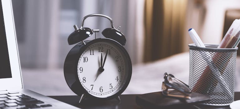 a black clock on a desk