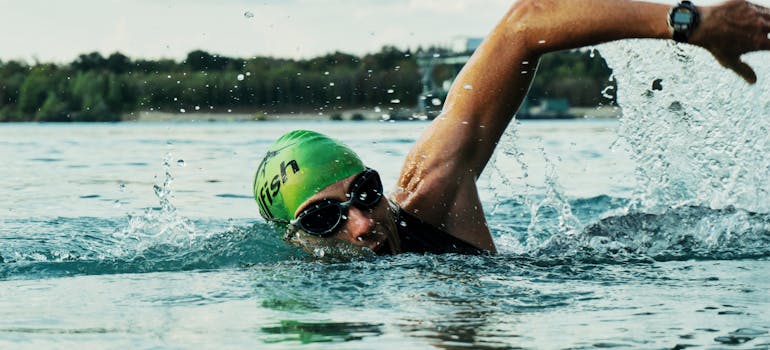 a man swimming in a lake after successfully moving to Lake Forest with teenagers