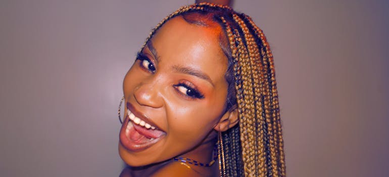 a woman with braids and a very happy expression on her face