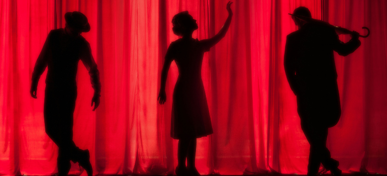 three people performing in a theater