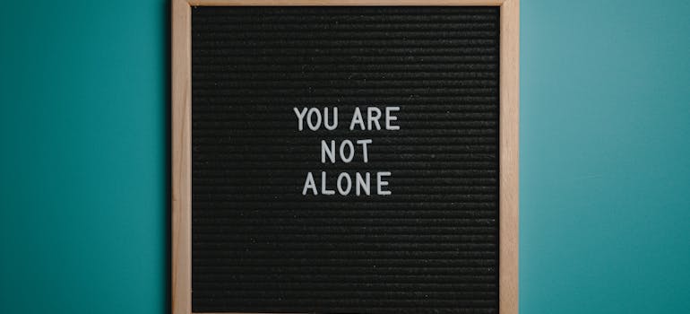 a blackboard with the statement "You are not alone" on it