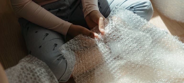 a woman handling a piece of bubble pack