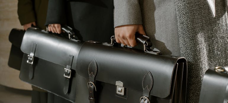 several lawyers holding business bags you might want to consult before you set up a company in Orange County