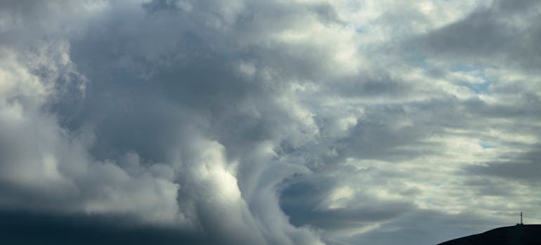 a sky that indicates a hurricane may be near, which is a problem for those who are moving to a coastal city.