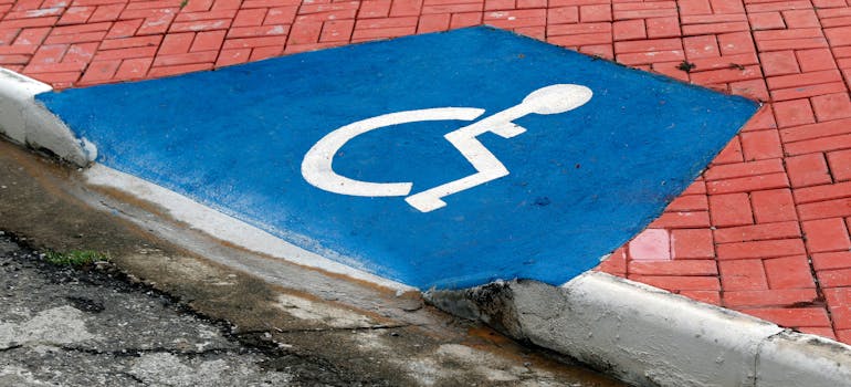 Blue sign indicating access for people in wheelchairs which you'll see after moving with a disabled person to Orange County