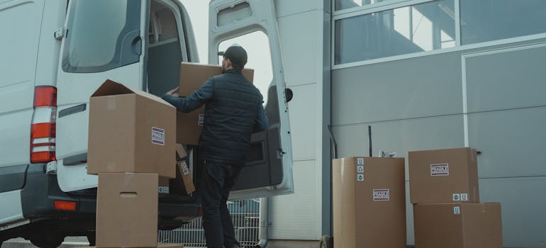 a professional mover taking the boxes into a van