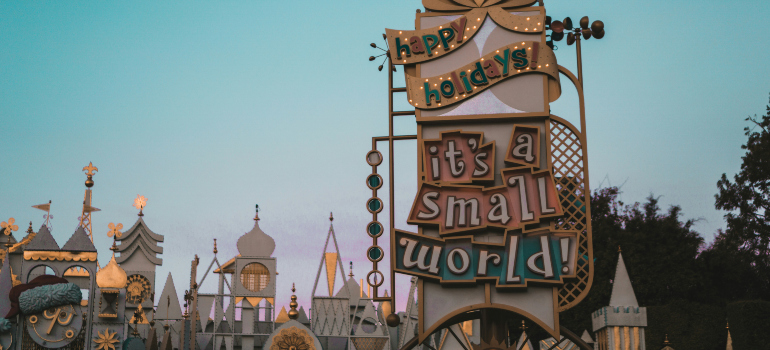 a structure in Disneyland with the inscription "It's a small world" people often see after moving to Anaheim after divorce