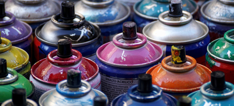 Close-up of spray paint cans, symbolizing hazardous non-allowable items.