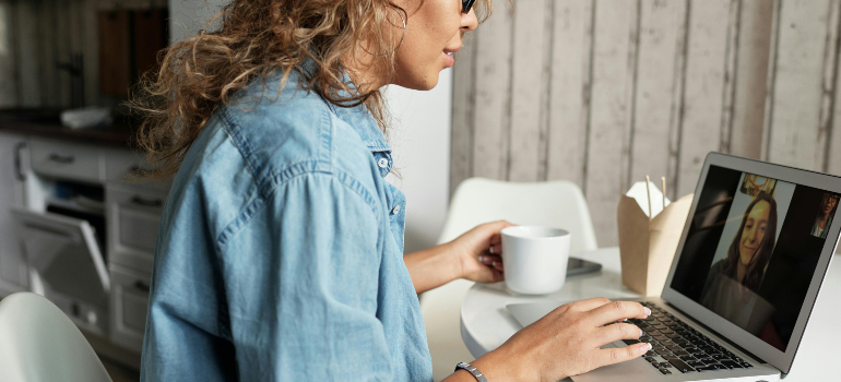 Woman on a video call to stay connected with loved ones after moving.