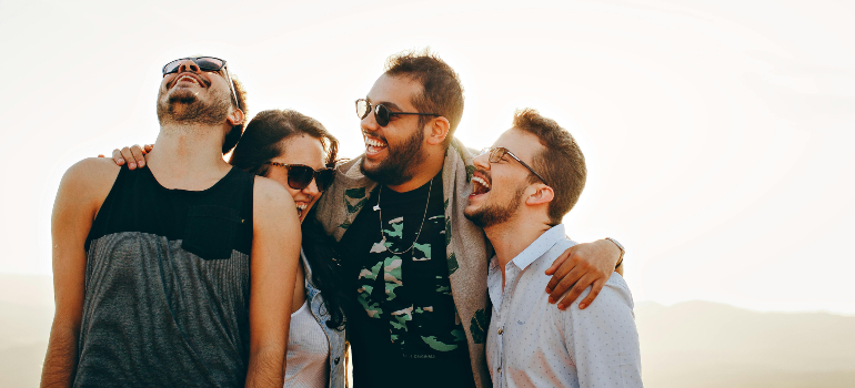 Friends laughing outdoors, showcasing the fun community vibe of living in Aliso Viejo.