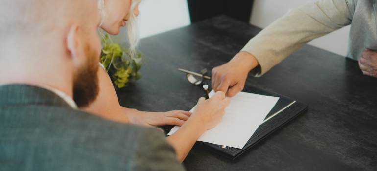 Woman signing a contract after moving your office in Anaheim