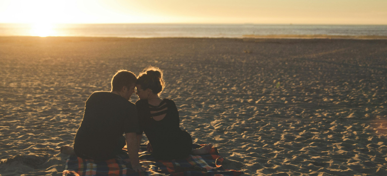 a couple having a picnic on a beach