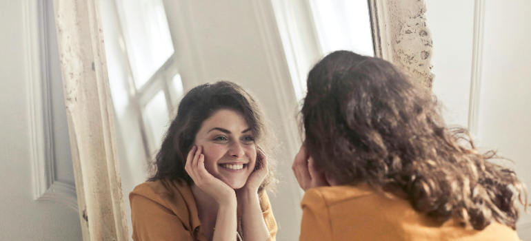 a girl looking in the mirror 