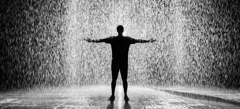 Person standing in heavy rain 