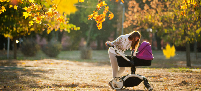 a mom and a baby in a park