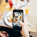 Person taking a photo at one of the best brunch Spots in Irvine