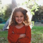 A girl smiling in a park